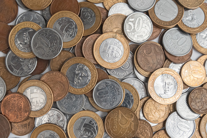 A collection of various international coins scattered.